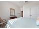 Comfortable bedroom offers ample natural light and a view of the closet and hallway at 3677 Turning Tides Ter, Bradenton, FL 34208