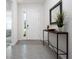 Inviting entryway with neutral tones, console table, and stylish decor, leading to a bright, airy living space at 3677 Turning Tides Ter, Bradenton, FL 34208