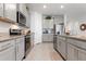 Modern kitchen featuring stainless steel appliances and granite countertops at 3677 Turning Tides Ter, Bradenton, FL 34208