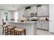 Modern kitchen with a large island, granite countertops, and stainless steel appliances at 3677 Turning Tides Ter, Bradenton, FL 34208