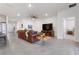 Open-concept living room featuring tile floors, a leather sofa, and a view into the bedroom at 3677 Turning Tides Ter, Bradenton, FL 34208