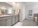 Bright main bathroom featuring double sinks, cabinets and a door to the toilet and bathtub at 3677 Turning Tides Ter, Bradenton, FL 34208