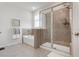 Bright main bathroom featuring tile floors, a bathtub, a glass-enclosed shower and towels at 3677 Turning Tides Ter, Bradenton, FL 34208