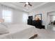 Bright main bedroom with carpet floors, tray ceiling, two windows and an opening to the main living area at 3677 Turning Tides Ter, Bradenton, FL 34208