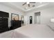 Bright main bedroom featuring carpet floors, a tray ceiling, closet and an opening to the main living area at 3677 Turning Tides Ter, Bradenton, FL 34208