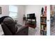 Cozy home office with leather seating, bookshelves, and a calming atmosphere at 3677 Turning Tides Ter, Bradenton, FL 34208