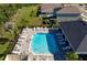 Community pool with sun loungers and ample space for recreation and relaxation at 3677 Turning Tides Ter, Bradenton, FL 34208
