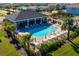 A stunning aerial perspective of the community pool, showcasing the outdoor lounge area and pristine landscaping at 3677 Turning Tides Ter, Bradenton, FL 34208