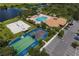 Aerial view of the community amenities, including the pool, clubhouse, parking, and courts at 374 Fairway Isles Ln, Bradenton, FL 34212