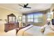 A bedroom features a large window, ceiling fan, and traditional furniture at 374 Fairway Isles Ln, Bradenton, FL 34212