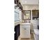 Charming bathroom with granite countertop vanity, framed mirror and matching dark wood upper cabinet at 3807 41St Street W Ct # 52, Bradenton, FL 34205