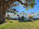 Spacious backyard featuring a patio area, mature tree, and well-maintained lawn at 4 Braden Castle Dr, Bradenton, FL 34208