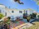 Cozy backyard patio with outdoor seating, a colorful rug and lovely landscaping at 4 Braden Castle Dr, Bradenton, FL 34208