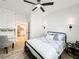 Bedroom with ceiling fan, light walls, and walk-in to kitchen at 4 Braden Castle Dr, Bradenton, FL 34208