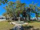 Charming community park featuring a tiered fountain, lush trees, and sidewalks at 4 Braden Castle Dr, Bradenton, FL 34208