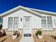 Charming single-story home with white stucco exterior, brick accents, and well-manicured landscaping at 4 Braden Castle Dr, Bradenton, FL 34208
