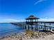 Picturesque waterfront pier featuring covered gazebo with calm blue waters and clear sky views at 4 Braden Castle Dr, Bradenton, FL 34208