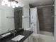 Bathroom featuring a dark granite counter, white floors and a shower with grey subway tile at 4031 Iola Dr, Sarasota, FL 34231