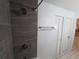 Shower featuring grey subway tiles, brushed steel fixtures, and a white tiled floor at 4031 Iola Dr, Sarasota, FL 34231