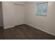 Bright bedroom features wood-look flooring, closet, and a window providing natural light and creating a cozy atmosphere at 4031 Iola Dr, Sarasota, FL 34231