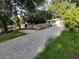 A secluded home features a long gravel driveway and private backyard, offering space and tranquility at 4031 Iola Dr, Sarasota, FL 34231