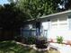 Charming home exterior with a welcoming porch, well-maintained landscaping, and a freshly painted facade at 4031 Iola Dr, Sarasota, FL 34231