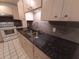 Kitchen with stainless steel sink, granite counters, tile backsplash and light wood cabinetry at 4031 Iola Dr, Sarasota, FL 34231