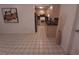 Living space with tile floor that leads to kitchen featuring light wood cabinets and dark countertops at 4031 Iola Dr, Sarasota, FL 34231