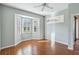 Bright bedroom featuring a window seat, wood floors, and plantation shutters at 4122 Bella Pasque, Venice, FL 34293