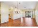 Spacious living room with tile floors, chandelier, and sliding glass doors to the lanai at 4122 Bella Pasque, Venice, FL 34293