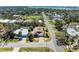 Aerial view of a home with a brown roof and mature trees at 417 Tortuga Dr, Nokomis, FL 34275