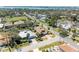 Aerial view of a home with a brown roof and mature trees at 417 Tortuga Dr, Nokomis, FL 34275