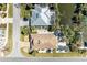 Aerial view of a house nestled among lush tropical landscaping with a pond, screened pool and neighboring homes at 417 Tortuga Dr, Nokomis, FL 34275