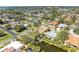 Aerial view showcasing a waterfront neighborhood with mature trees, diverse home styles, and waterway access at 417 Tortuga Dr, Nokomis, FL 34275