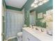 Bathroom featuring bright lighting, vanity, mirror, toilet and shower-tub combination with curtain at 417 Tortuga Dr, Nokomis, FL 34275