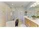 Bright bathroom featuring double sink vanity, decorative mirror, tiled flooring and a large glass-enclosed shower at 417 Tortuga Dr, Nokomis, FL 34275