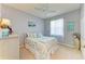Cozy bedroom with coastal decor, ceiling fan, and natural light from large window at 417 Tortuga Dr, Nokomis, FL 34275
