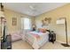 Comfortable bedroom with neutral decor, ceiling fan, and plenty of natural light at 417 Tortuga Dr, Nokomis, FL 34275