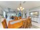 Open concept dining room with modern chandelier and view into the formal living room at 417 Tortuga Dr, Nokomis, FL 34275