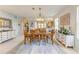 Light filled dining room with a decorative area rug and an adjacent kitchen and bonus room at 417 Tortuga Dr, Nokomis, FL 34275