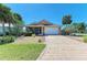 Beautiful home features a well-manicured lawn, two car garage and a brick paved driveway at 417 Tortuga Dr, Nokomis, FL 34275