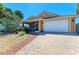 Well maintained home features a two car garage, manicured landscaping, and brick paved driveway at 417 Tortuga Dr, Nokomis, FL 34275