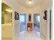 Bright hallway between bedrooms and bathrooms with tile flooring and an antique desk at 417 Tortuga Dr, Nokomis, FL 34275