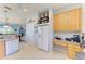 Kitchen with white appliances, tile floors, and adjacent breakfast nook at 417 Tortuga Dr, Nokomis, FL 34275