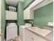 Functional laundry room featuring a washer, dryer, utility sink, and ample storage cabinets at 417 Tortuga Dr, Nokomis, FL 34275