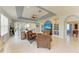 Bright living room features large windows, elegant furniture, and a modern ceiling fan at 417 Tortuga Dr, Nokomis, FL 34275