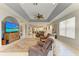 Expansive living room with tray ceilings, neutral decor, and tile flooring throughout at 417 Tortuga Dr, Nokomis, FL 34275