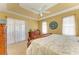 Spacious main bedroom featuring tray ceiling, ceiling fan, dresser, and sliding glass doors to lanai at 417 Tortuga Dr, Nokomis, FL 34275