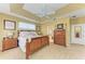 Spacious main bedroom with tray ceiling, neutral walls, and comfortable furnishings at 417 Tortuga Dr, Nokomis, FL 34275