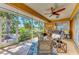 Inviting screened porch with comfortable seating, ceiling fan, and scenic outdoor views at 417 Tortuga Dr, Nokomis, FL 34275